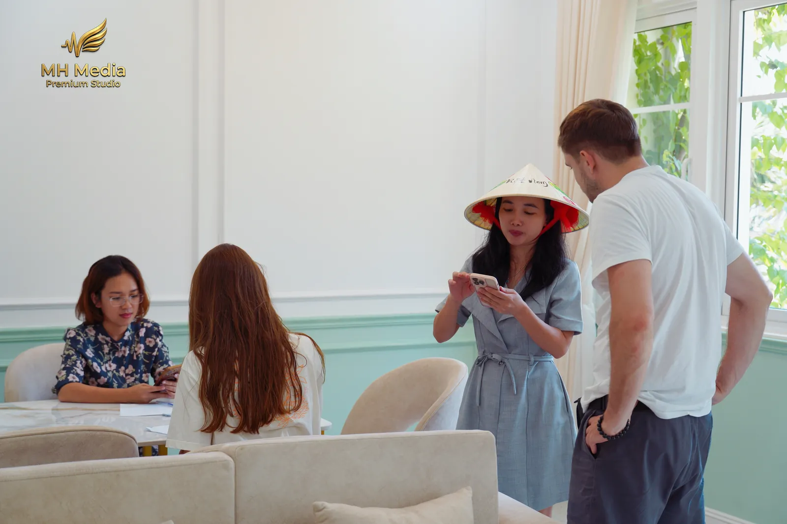 MH Travel staff giving a Vietnamese conical hat as a welcome gift to a monthly villa guest